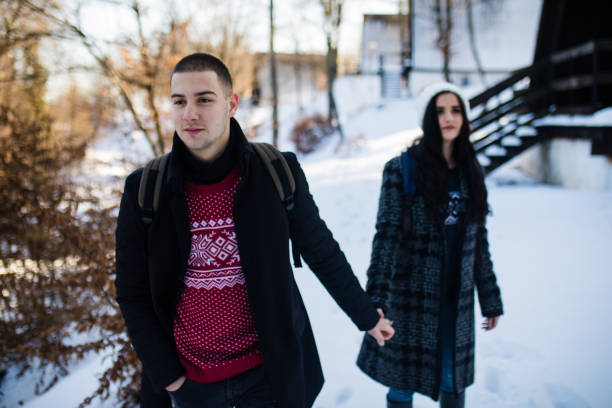 Romantic couple is walking in the winter park