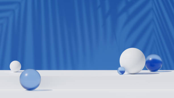 istock White podium with abstract glossy and blue transparent spheres. Palm tree leaf shadow on the blue wall on the background. Minimalist background for product presentation. 1811099639