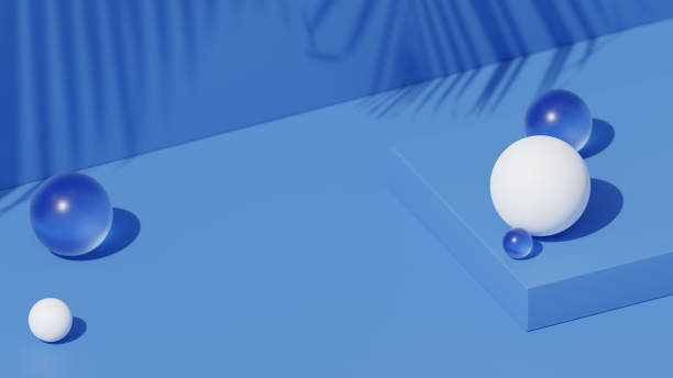 istock Blue podium with glossy and blue transparent spheres. Palm tree leaf shadow on the background. Minimalist background for product presentation. 1811100145