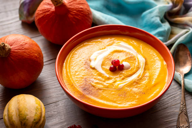 istock Pumpkin soup puree on a rough rustic wooden background. 1811105500
