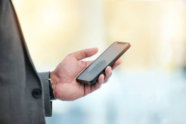 istock Businessman with phone in hand, checking email and networking with communication. Contact, connectivity and man with smartphone, mobile app or internet search for professional with blurred background 1811112816