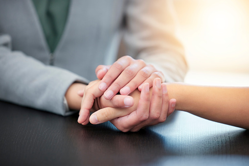 Therapy, client empathy and people holding hands together for consultation meeting, help or closeup support. Psychology service, mental health psychologist or depression counseling for trauma patient
