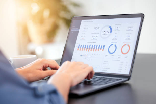 istock Business person, laptop and marketing with statistics in analytics, graph or chart data at office. Closeup of employee or analyst on computer for corporate profit, finance or ROI revenue at workplace 1811113895