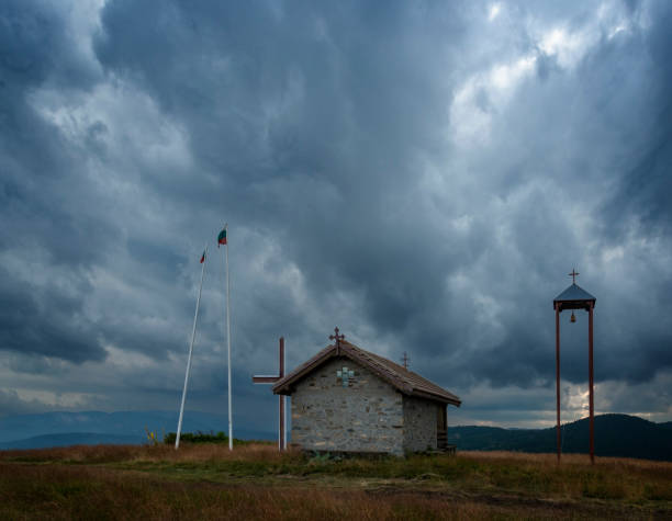 Dramatic sky over chapel high in the Rhodope Mountains. Bulgaria, Europe.