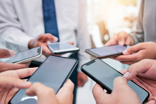 istock Business people, hands together and phone in circle for networking, communication or collaboration. Contact, connectivity and team with smartphone, mobile app and internet search with technology. 1811114440