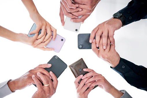 Business people, hands and phone in circle from below for networking, communication or collaboration. Contact, connectivity and team with smartphone, mobile app or internet search with technology.