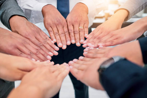 istock Hands, group circle and business people solidarity, unity and together in support, trust or closeup team building. Company mission, corporate meeting and community cooperation, synergy or commitment 1811114459