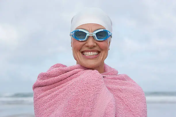 Photo of woman at the beach wrapped in a towel