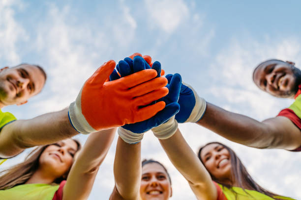 istock Nature Conservation Volunteers Having A Team Handshake In The Nature 1811128667