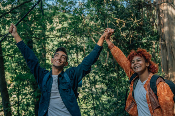 istock happy young couple with backpacks in nature on excursion or trip practicing hiking 1811129269