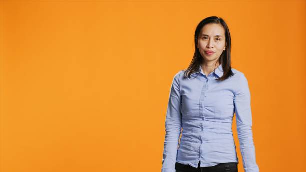 istock Asian person presenting something to studio sides 1811140289