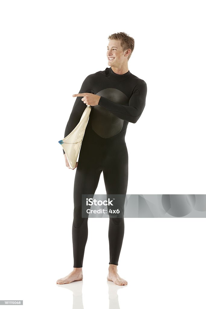 Male surfer with a surfboard pointing sideways Male surfer with a surfboard pointing sidewayshttp://www.twodozendesign.info/i/1.png 18-19 Years Stock Photo