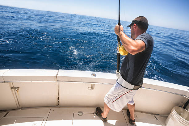 Deep Sea Fisherman Young Man Deep Sea Fishing big game fishing stock pictures, royalty-free photos & images