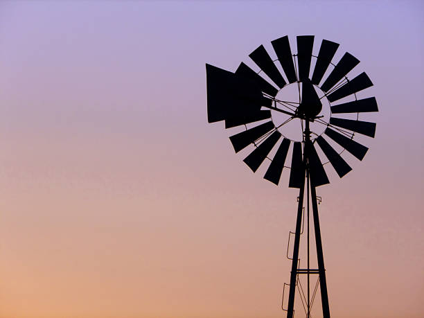 istock Windmill silhouette at dawn or dusk - horizontal 181115396