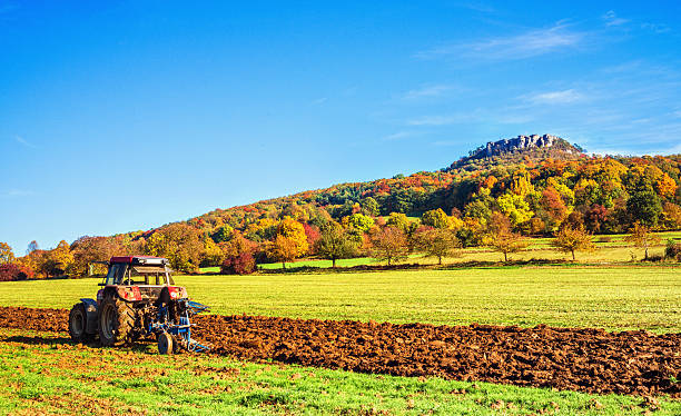 Autumn Agriculture in rural Franconia Beautiful Autumn scenery with tractor plowing the land in rural Franconia, Bavaria/Germany. bamberg photos stock pictures, royalty-free photos & images
