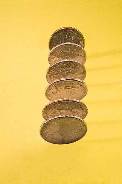 istock Six American Quarters upright on yellow background 181115637