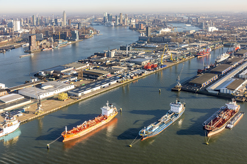 Aerial view Dutch industrial harbor Botlek near Rotterdam with harbors and loading and unloading ships