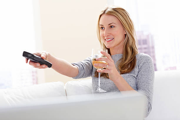 istock Beautiful woman watching television 181115706