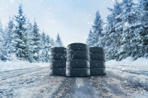 set of winter tires on the road in the snow - street fog profile imagens e fotografias de stock