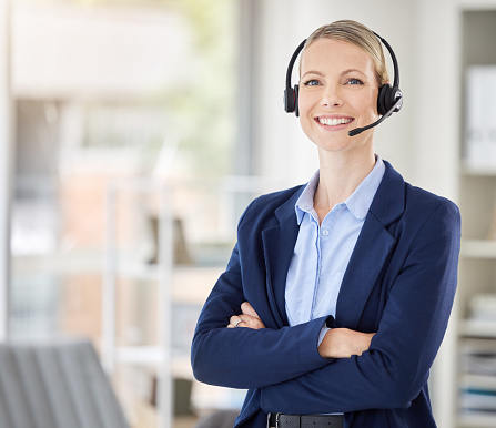 Call center woman and success manager smile with headset on telemarketing and support call at office. Customer service consultant, crm agent or employee consulting or helping with contact us question