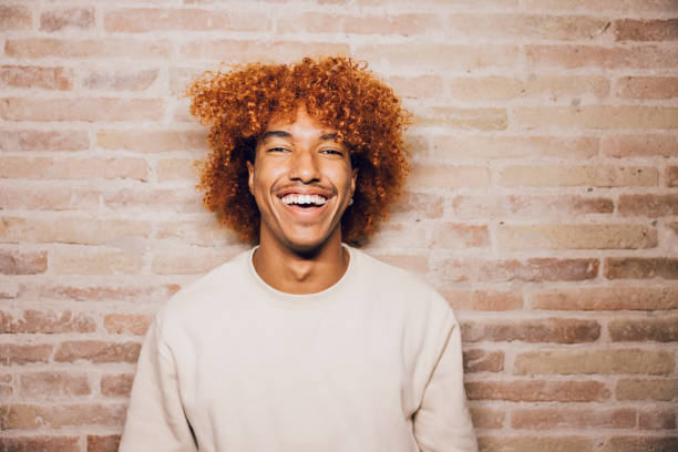 istock Portrait of a young man with a brick wall background. 1811166923