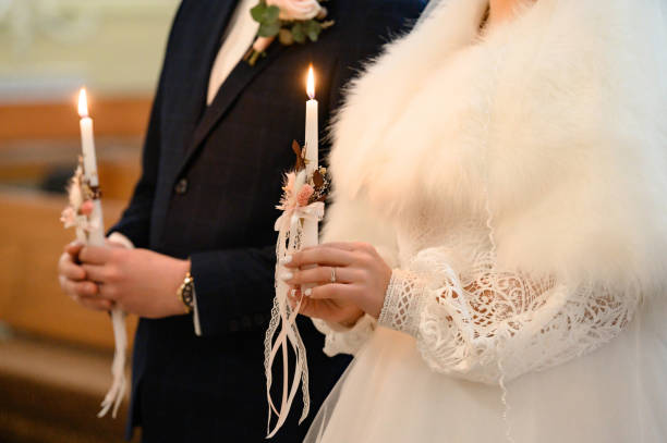 istock The bride and groom hold lit candles in their hands. 1811169100