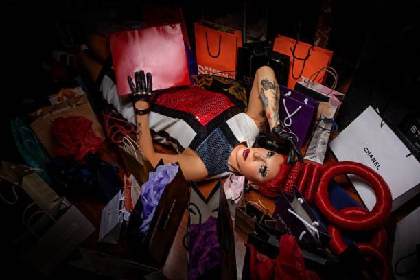 Drag queen surrounded with shopping bags