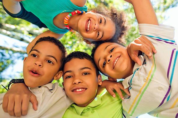 istock Four children hugging outdoors 181117381