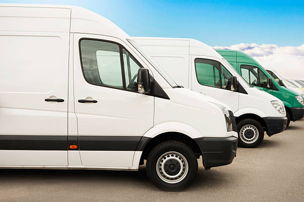 istock Parked group of white vans / service vehicles after work 181117731