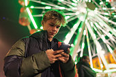 Teenage boy using phone in center of Lodz, Poland