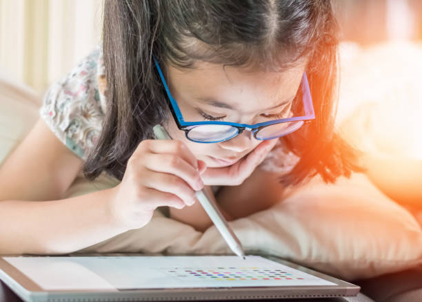 istock School child, girl kid using internet online learning and reading e-book on mobile tablet app for educational studying and playing game for recreational relaxation in digital technology lifestyle 1811182497