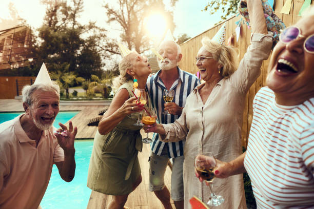 istock Carefree mature friends having fun on a pool party. 1811189070