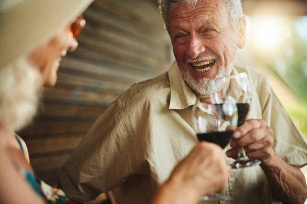 istock Cheerful mature couple toasting with wine on a patio. 1811192297