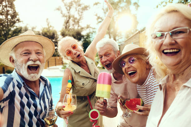 istock Cheerful senior friends having fun on a pool party. 1811194017
