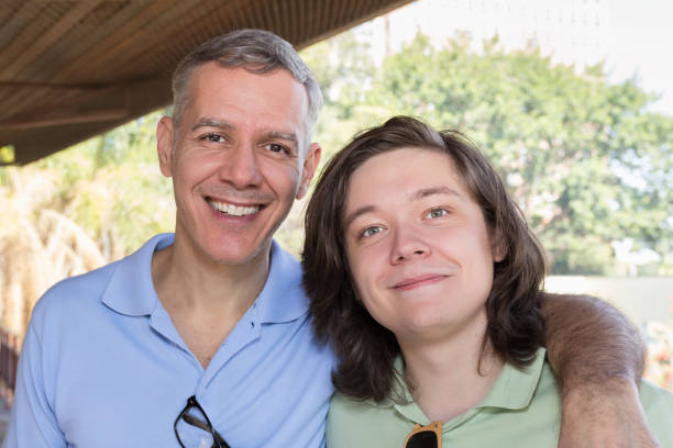 istock Grey haired dad and young adult son smiling. 1811203305