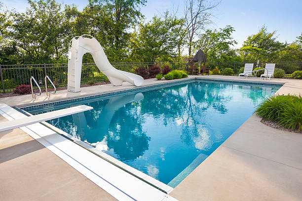 istock Idyllic Swimming Pool With Slide, Diving Board 181121097
