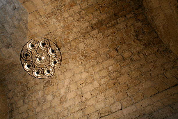 Medieval chandelier in stone brick cavern stock photo