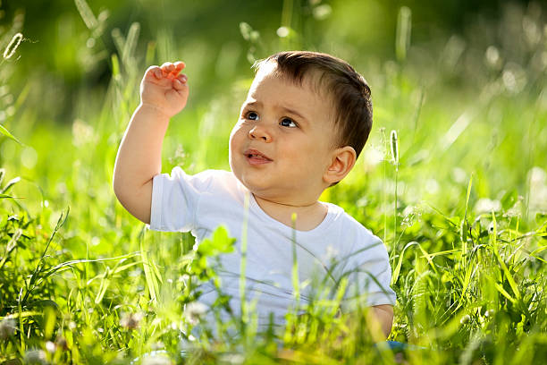 istock Little boy playing in the grass 181121700