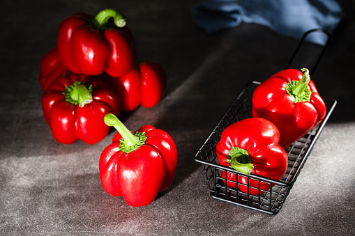 sea salt, dry spices, yellow, red hot chili peppers, different greenery, on cracks black background, panorama