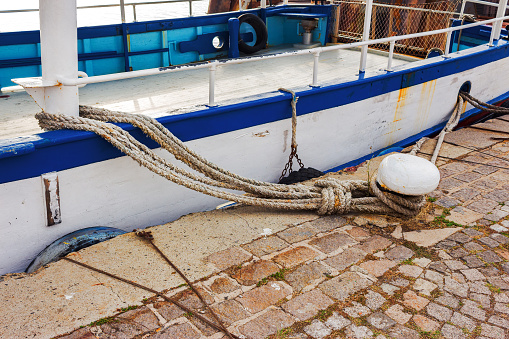 Close up of a white roped ship at the harbor