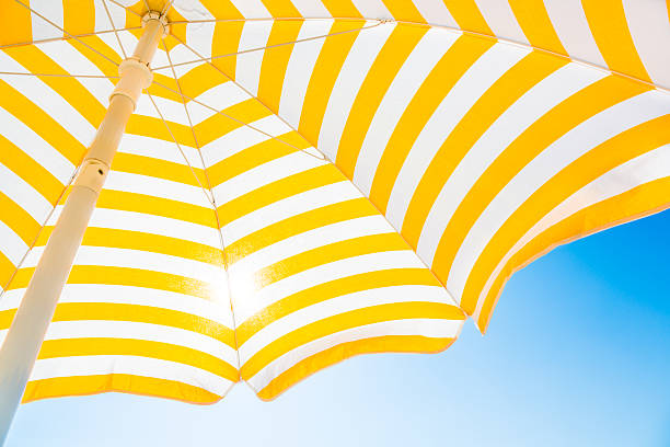 Beach umbrella against blue morning sky