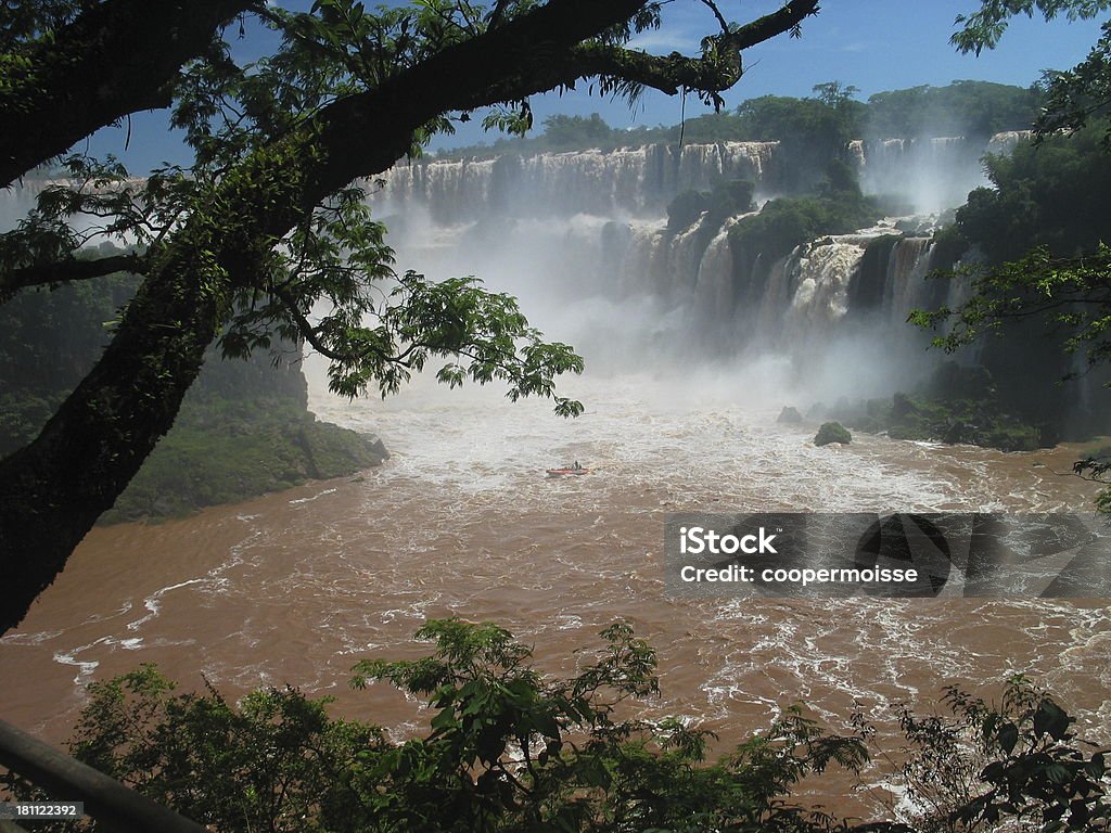 Iguazu Falls, Argentina Tour boat struggles through the churning muddy waters of Iguazu Falls, widest in the world. Argentina Stock Photo