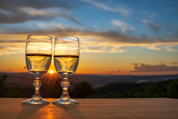 istock Two glasses of champagne with sunset background 1811232408