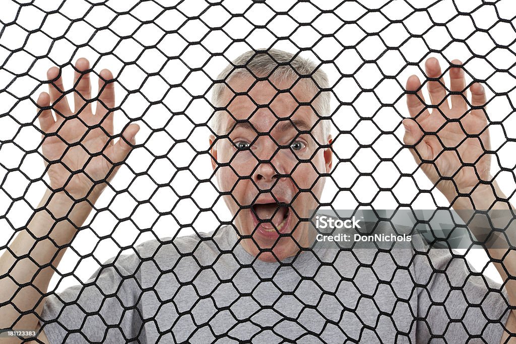 Homem olhando através de rede - Foto de stock de 40-49 anos royalty-free