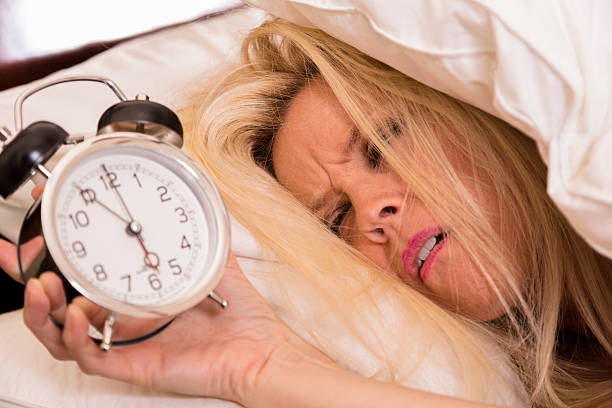 istock Time: Woman does not want to wake for alarm clock. 181123989
