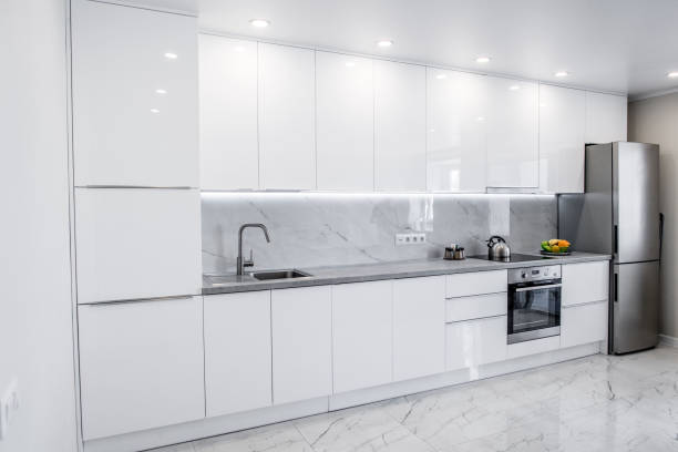 istock Image of modern white kitchen with many cabinets and appliances 1811243245