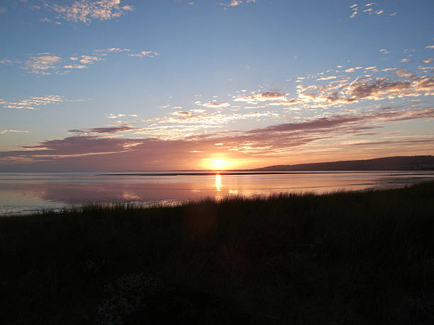 istock Sunset over estuary with tide coming in 181124596
