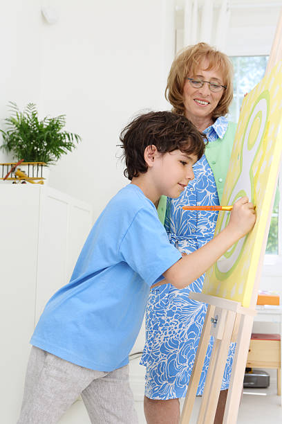 istock Painting with grandmother 181125185