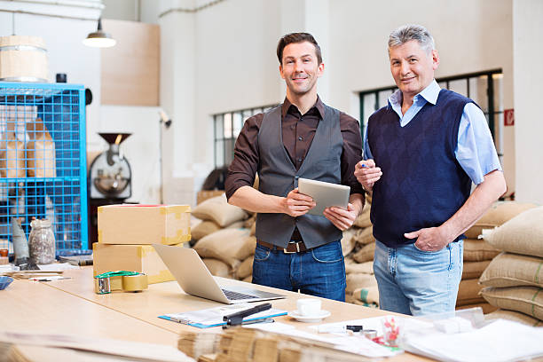 istock Two men standing in coffee roast storage room 181126583