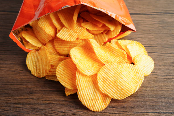 istock Potato chips in open bag, delicious BBQ seasoning spicy for crips, thin slice deep fried snack fast food. 1811266062
